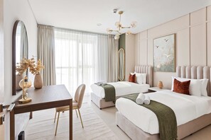 A hotel room with two beds, a desk, a chair, a large mirror, and a chandelier. - Silkhaus Vacation Homes Premium 2bdr With Maid Room in Radiant Viewz (Abu Dhabi)