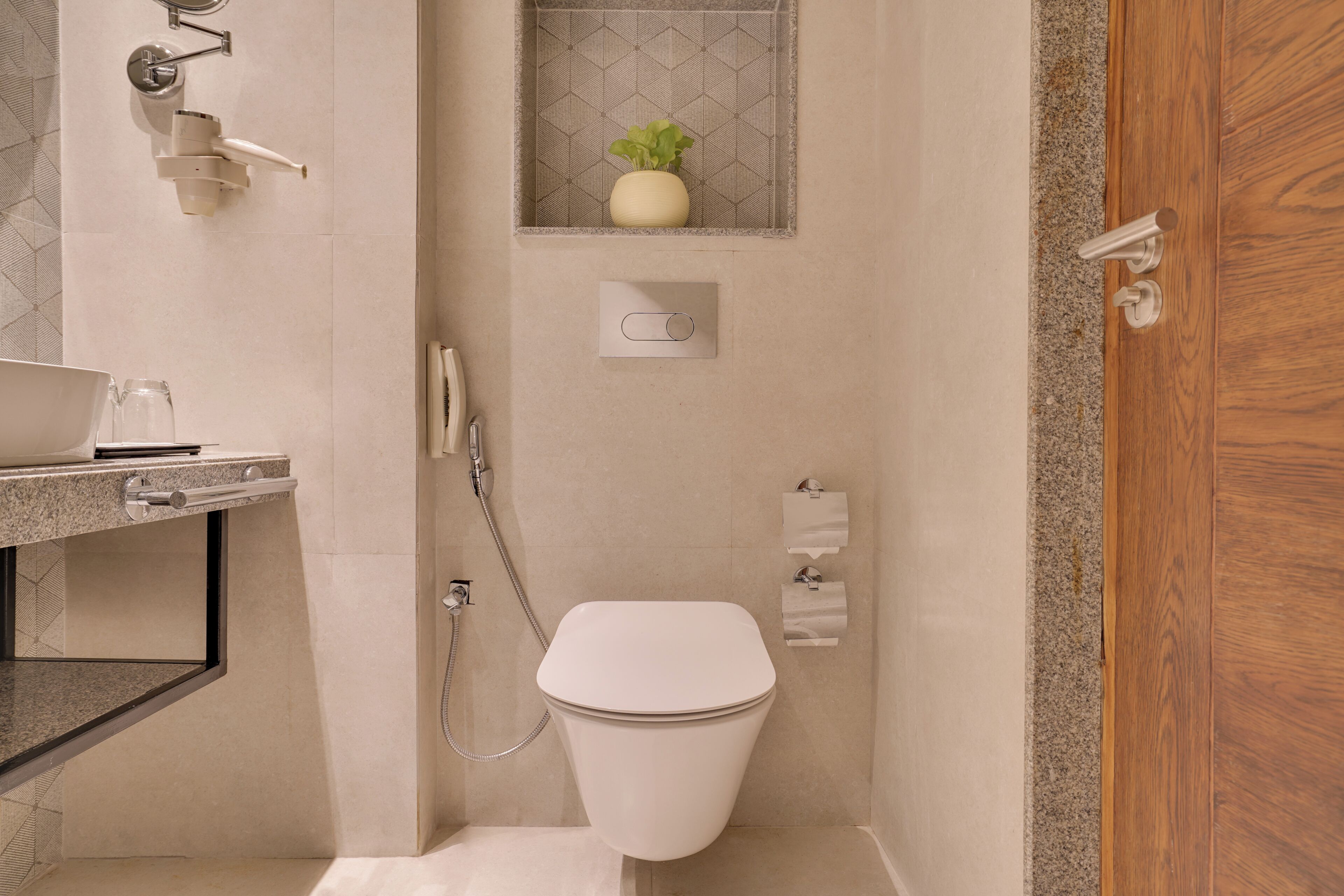 A bathroom with a toilet, shower, and sink.