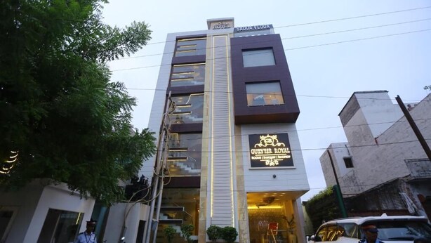 A hotel with a modern facade, multiple floors, and a sign indicating it is a hotel. - Hotel Gurveer Royal (Lucknow)