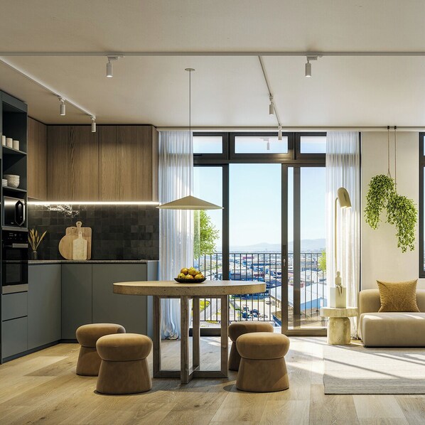 A modern kitchen with a dining area, large windows, and a view of the city.