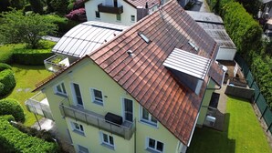 A multi-story building with a sloped roof, multiple windows, and a balcony. - Apartment 'Am Lindenhof' with Balcony and Wi-Fi (Lindau (Bodensee))