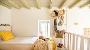A bedroom with a bed, a window, a wardrobe, and a balcony railing. - Opus Apartment by Mykonian Hospitality (Mykonos)