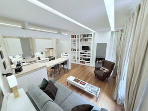 A modern living space with a kitchen, dining area, and seating area. - Campo dei Fiori. modern and quiet apartment with patio and A/C. (Roma)