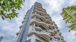 A tall building with a unique architectural design featuring balconies and windows. - Nova 2-bedroom apartment in Nairobi (Nairobi)