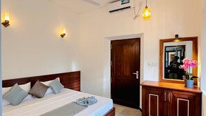 A bedroom with a bed, bedside lamps, a ceiling fan, an air conditioning unit, a wooden wardrobe, and a mirror. - The Ridgecolonial Villa 10 min Walk to Beach (Ahangama)
