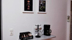 A coffee bar with a coffee maker, a coffee mug, and a coffee bar display. - Art House by Helen in Soroni Rhodes (Rhodes)