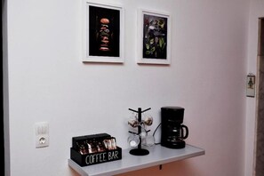A coffee bar with a coffee maker, a coffee mug, and a coffee bar display. - Art House by Helen in Soroni Rhodes (Rhodes)