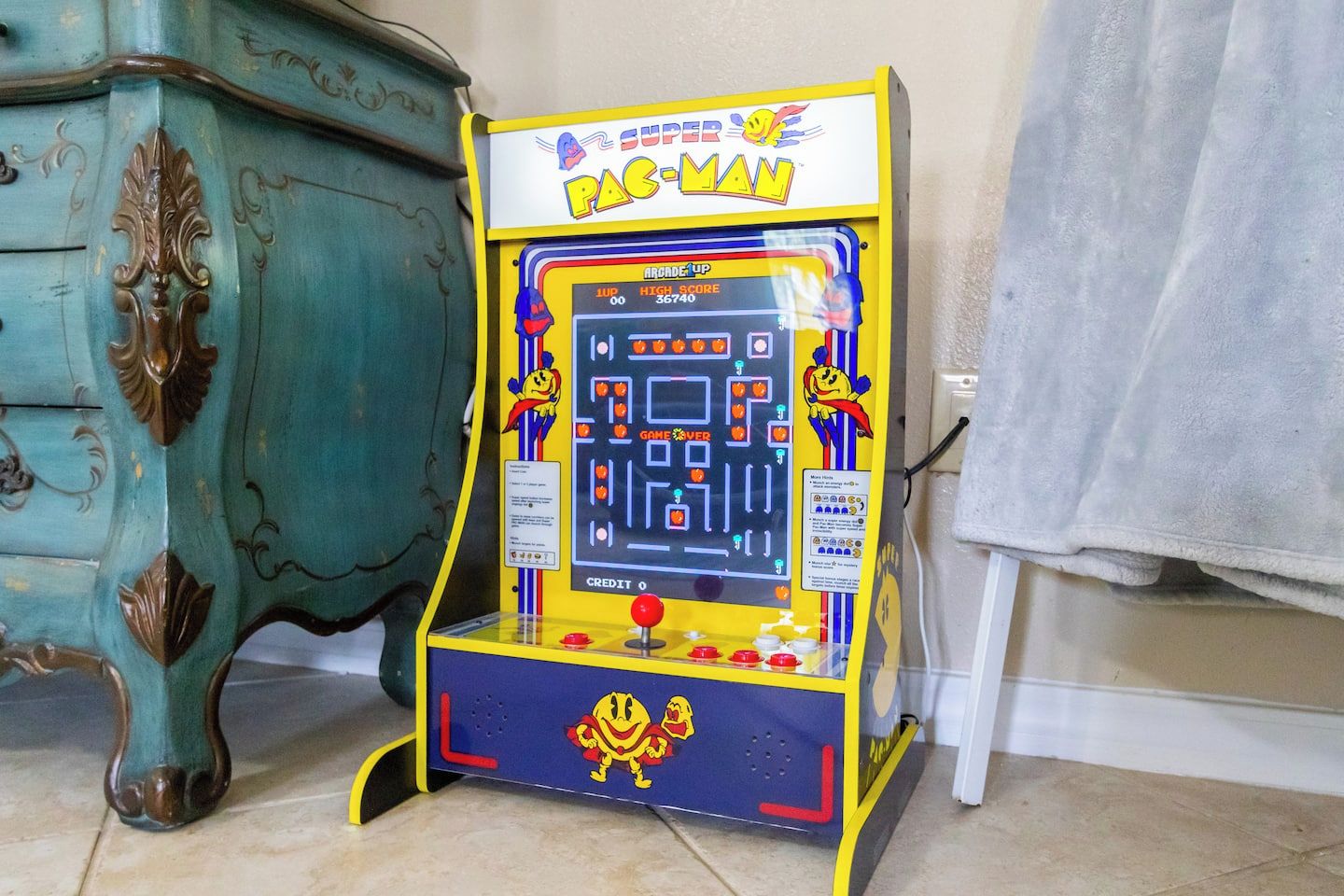 A Pac-Man arcade game machine with a score display, joystick, and coin slot.