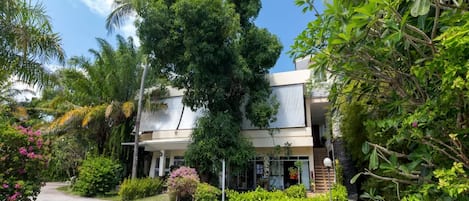 A modern two-story building with a paved driveway leading to the entrance.