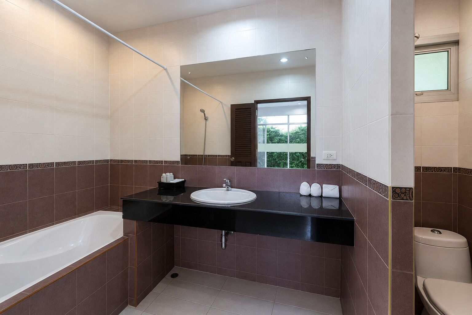 A modern bathroom with a bathtub, a sink, and a toilet.
