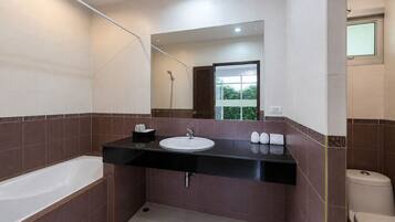A modern bathroom with a bathtub, a sink, and a toilet.