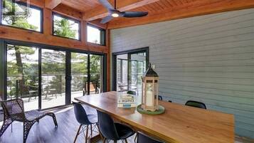 A wooden dining table with chairs, a lantern, and a sign reading 'SEQUENCE.'