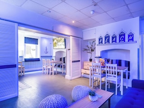 A modern interior with a dining area, kitchen, and living space. - The Wellington Apart Hotel by Guestz (Blackpool)