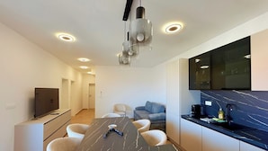 A modern kitchen with a dark marble countertop, a built-in oven, and a black faucet. - Apartment Top 5 with sunny balcony and sea view (Novalja)