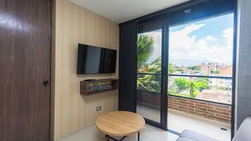 Family Loft, Balcony, City View | Living area | 40-cm flat-screen TV with digital channels