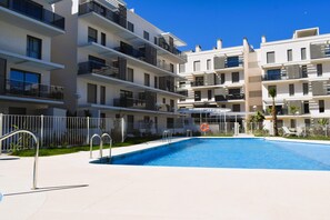 A modern apartment building with a swimming pool, balconies, and a fenced area. - Ap1142 in Denia With 1 Bedrooms and 1 Bathrooms (Denia)