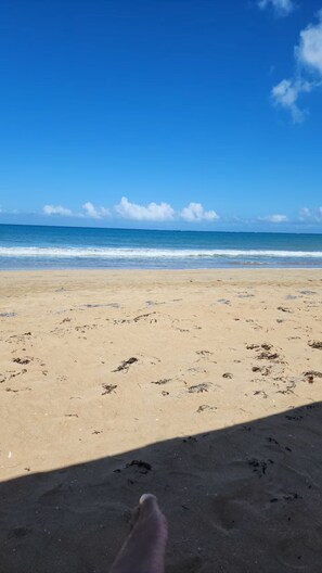 A beach with footprints, a clear sky, and the ocean. - Casa Oasis #4 - Cozy 1br apartment in lovely San Juan with AC and Solar Power (San Juan)