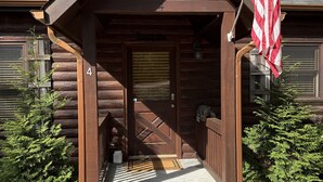 A wooden lodge with a stone staircase leading to a door marked with the number 4. - Tranquility Cabin: Secluded Mountain Escape with Game Room, Fire Pit & Hot Tub (Blue Ridge)
