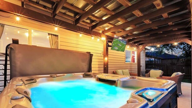A hot tub with a wooden ceiling and a television screen. - 8 mi Lackland AFB BMT HotTub Game Room Bocce Ball (San Antonio)