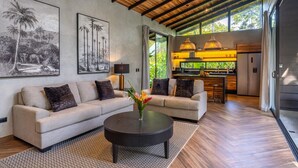 A modern living room with a sofa, coffee table, and artwork on the walls.