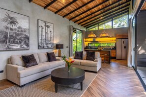 A modern living room with a sofa set, a coffee table, and artwork on the walls. - Hidden House: Luxury, Private Pool, 4WD Only (Punta Uva)