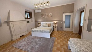 A bedroom with a bed, bedside tables, a dresser, a rug, and a ceiling light fixture. - ThreeZeroThree House • With Private Garden (Colombaro)