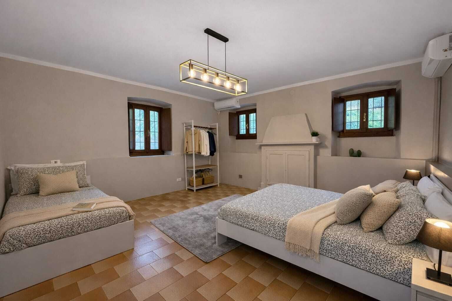 Un dormitorio con dos camas, un armario, un radiador y una ventana.