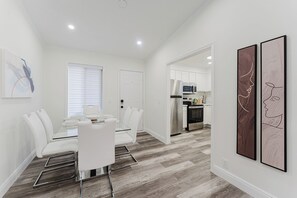A modern kitchen with white cabinets, a microwave, and a dishwasher. - Delray Beach 3BR: Walk to Atlantic Ave - Hot Tub & Game Room (Delray Beach)