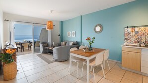 A modern living room with a dining area, a kitchen, and a large sliding glass door leading to a balcony. - Vacation Home 'Vistamar-lovely Renovated With' with Wi-Fi (La Matanza de Acentejo)