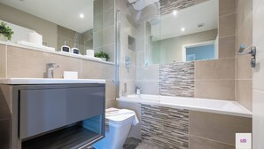 A modern bathroom with a shower, toilet, and vanity. - Brighton Central Seaview Retreat, Steps to the Beach (Brighton and Hove)