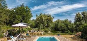 A wooden deck with a swimming pool, lounge chairs, and a hammock. - Bastide de 1855 au pied du Garlaban | Terrace, pool & Provencal charm (Aubagne)