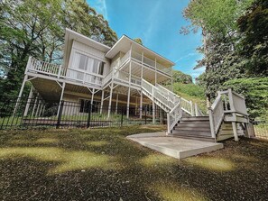 A two-story house with a balcony and a staircase leading to the upper level. - Five Bedroom Brookview Estate (Atlanta)