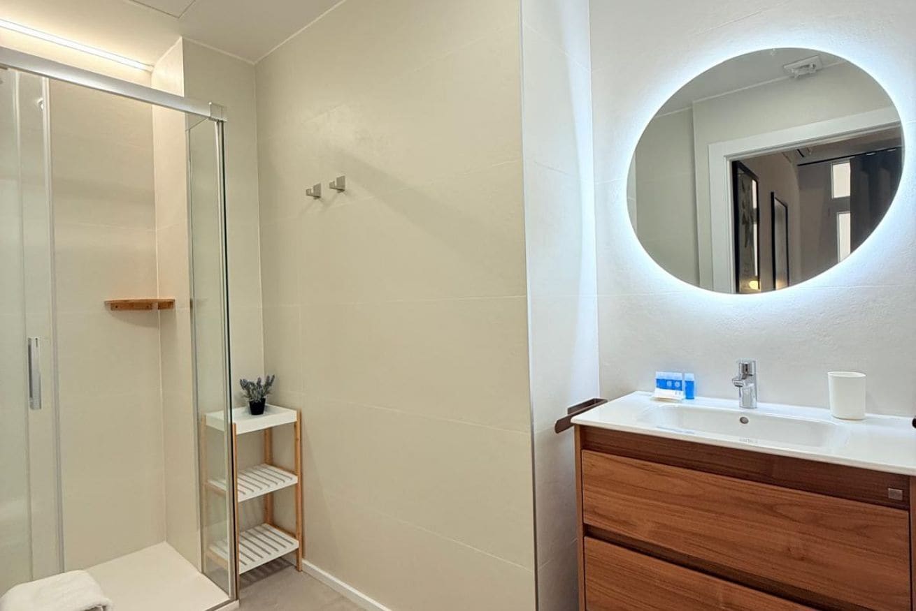 Een douche, handdoeken, shampoo, toiletpapier