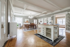 A spacious kitchen with a dining area, wooden flooring, and a chandelier. - Charming 5-BR estate in FLX perfect for relaxing stays. HOT TUB. GAME ROOM. POOL (Canandaigua)