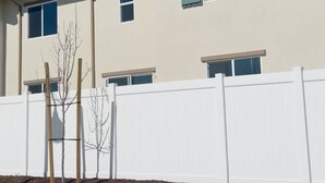 A two-story building with a white exterior, multiple windows with shutters, and a white fence in front. - Serene 3-bedroom townhome in charming Lompoc perfect for families (Lompoc)