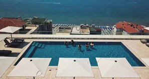 A swimming pool with people, sun loungers, and umbrellas. - All Inclusive stay by PS - Durres Bay  (Rrashbull)