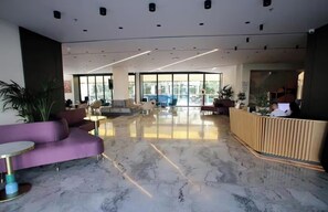 A modern lobby with a marble floor, a reception desk, and seating areas. - All Inclusive stay by PS - Durres Bay  (Rrashbull)