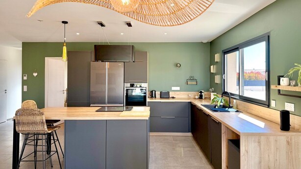 A modern kitchen with a central island, built-in appliances, and a large window. - Villa Les Vignes – 8 guests in the Gard (Saint-Chaptes)