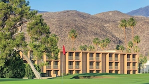 A hotel with a flat roof, multiple balconies, and a flagpole. - Palm Springs | Couples Desert Retreat | Pool + Hot Tub (Palm Springs)