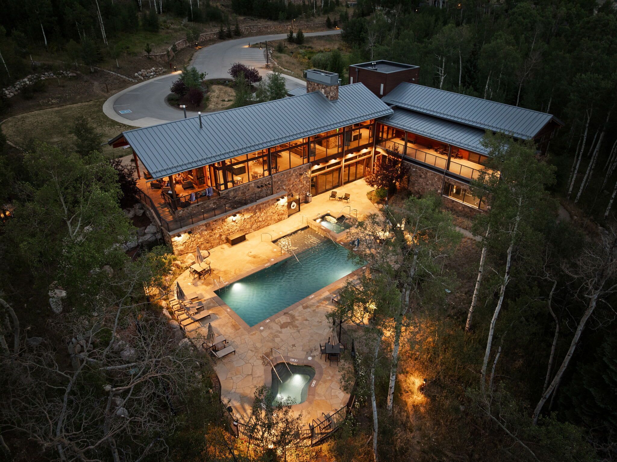 Summit Sky Ranch’s Aspen House offers a mountain retreat with a year-round pool, hot tubs, and beautiful outdoor spaces.