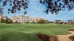A golf course with a hotel in the background. - Reunion | Upscale Golf Retreat | Pool + Golf | 3BR Sleeps 8 (Reunion)