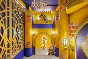 A room with a decorative wall, a chandelier, and a character statue. - 10 BD/ 8 BA/ Windsor Cay (1001 BP) (Clermont)