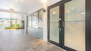 A spa entrance with glass doors, a reception desk, and a tiled floor.