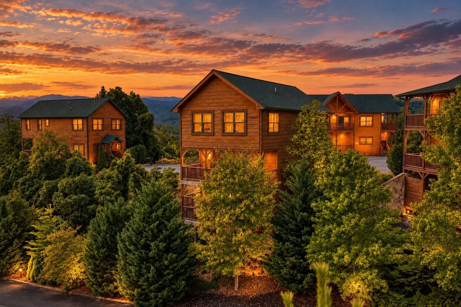 A multi-story wooden lodge with a balcony, surrounded by evergreen trees, set against a sunset sky.