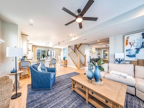 A spacious living room with a ceiling fan, a wooden coffee table, a blue sofa, and a beige sofa. - Relaxing Shore Escape with PRVATE POOL-Close to Beach, Boards & Dining (Ocean City)