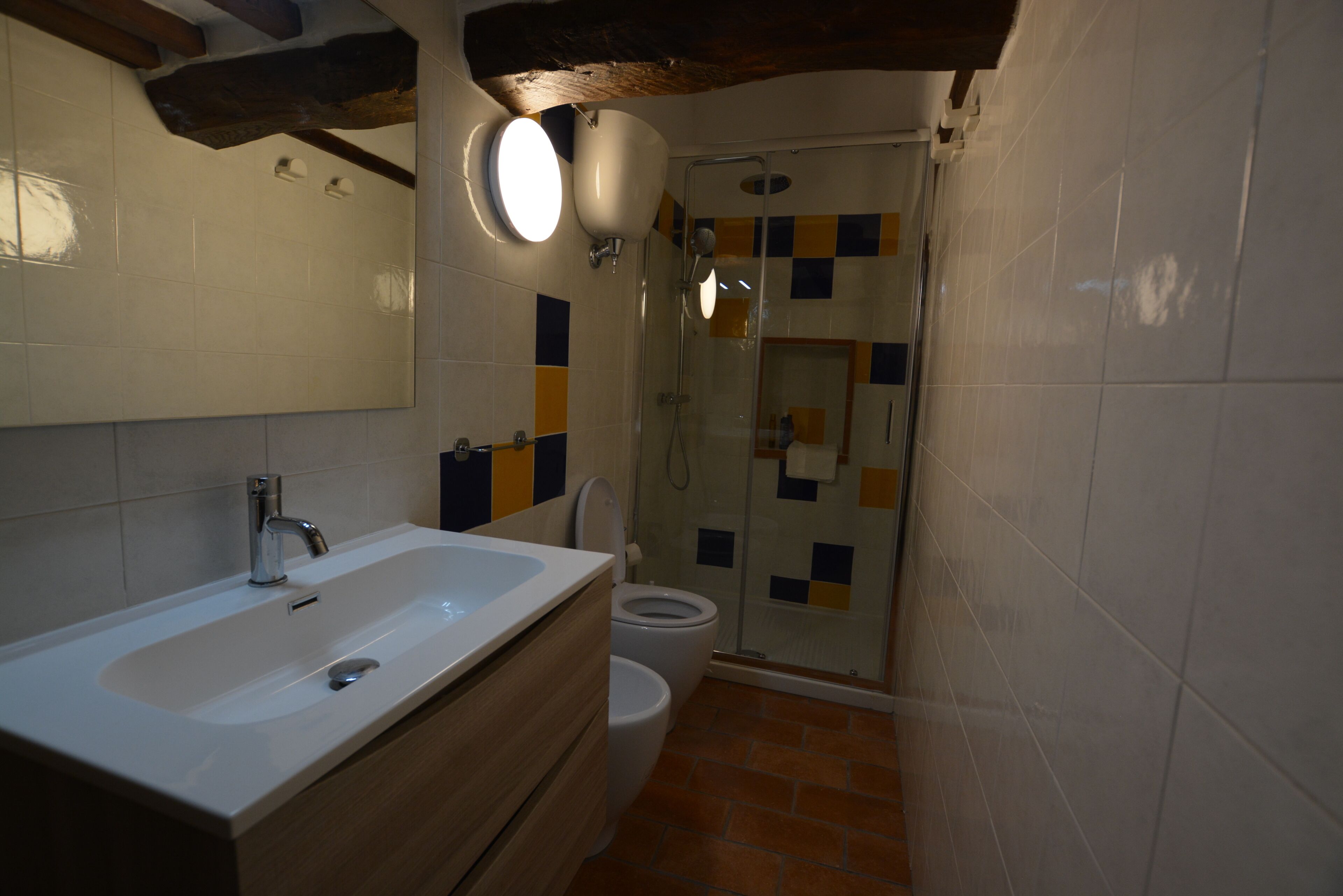 A bathroom with a sink, toilet, and shower.