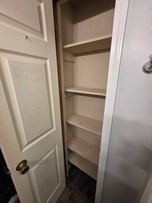 A white door with a brass doorknob, leading to a closet with three empty shelves. - Fantastic 3-bedroom house with AC in charming Lebanon (Lebanon)