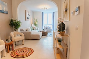 A modern living room with a sofa, armchairs, a coffee table, and a rug. - OneLuxStay Antwerp Near Central Station (Antwerp)