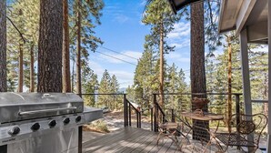 A deck with a Char-Broil grill, wicker chairs, and a small table. - Kings Beach Cabin w/ Panoramic Lakeview & Forest (Kings Beach)