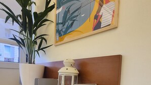 A wall-mounted shelf unit with a potted plant, a lantern, and a set of keys. - La Concha Apartment (Donostia / San Sebastián)